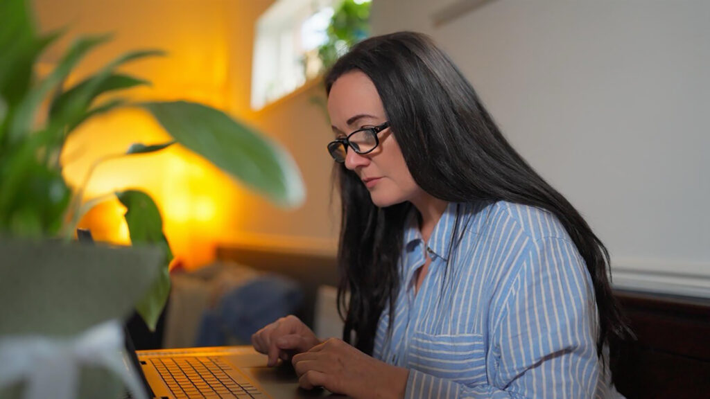 Ellie (Author) Typing at Table